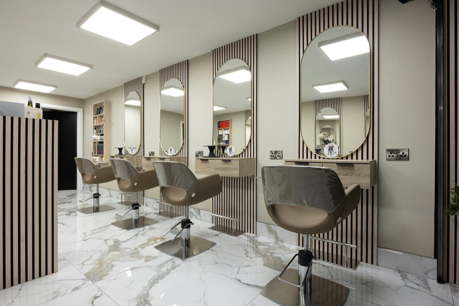 A modern beauty salon interior with mirrors and chairs